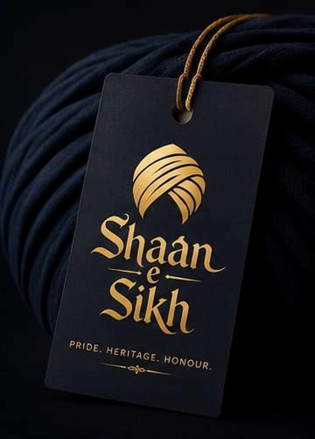 Shaan-e-Sikh gold-foiled tag on a bolt of royal navy turban cloth